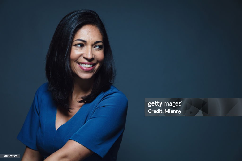 Happy smiling hispanic woman looking away