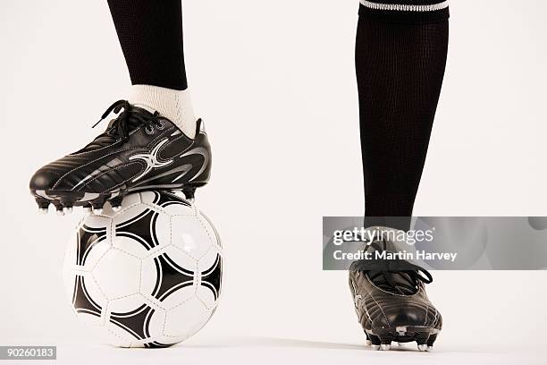 feet of soccer player with ball - studded stock-fotos und bilder