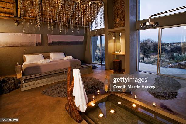 luxury lodge bedroom interior with sunken bath in namibia, africa - sunken bath stock pictures, royalty-free photos & images