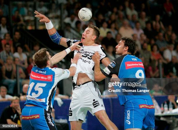 Gille Guillaume and Igor Vori of Hamburg and Filip Jicha of Kiel battle for the ball during the Handball Super Cup match between THW Kiel and HSV...