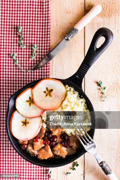 pork stew with dried cranberry served with couscous in a pan, top view - homemade apple sauce stock pictures, royalty-free photos & images