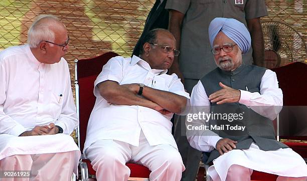 Prime Minister Manmohan Singh talks to Union Agriculture Minister Sharad Pawar and Union Minister for Non-Conventional Energy Farooq Abdullah during...
