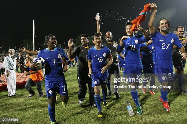 The Indian football team players Gouramangi Moirangthem Singh, Baichung Bhutia, Naduparambil Pappachen Pradeep and Mehrajuddin Wadoo take a victory...
