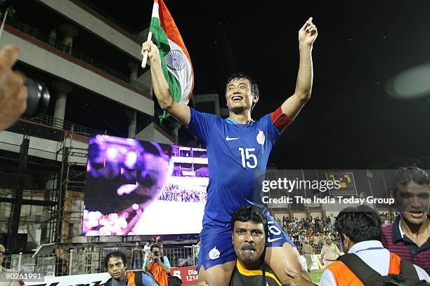 India captain Baichung Bhutia takes a round of the Ambedkar Stadium with the Indian flag after beating Syria in the Nehru Cup final on Monday, August...