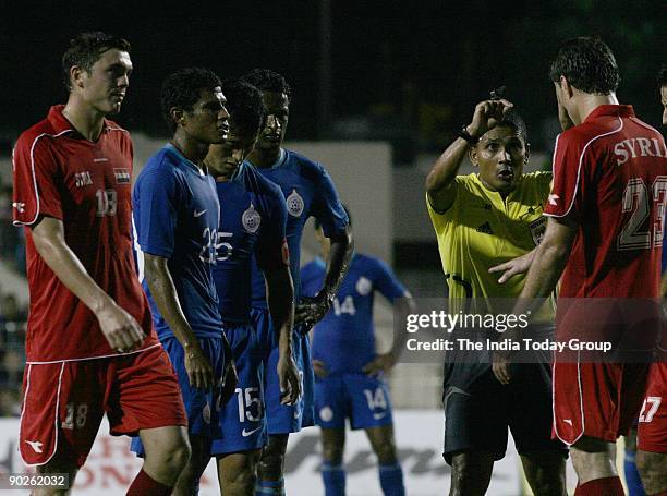 Referee Adil Ali talks to Feras Esmaeel of Syria as Abdul Fattah Alaga of Syria, Steven Benedic Dias and Baichung Bhutia of India watch during the...