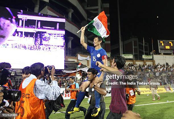 India captain Baichung Bhutia takes a round of the Ambedkar Stadium with the Indian flag after beating Syria in the Nehru Cup final on Monday, August...