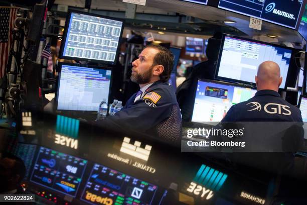 Traders work on the floor of the New York Stock Exchange in New York, U.S., on Monday, Jan. 8, 2018. U.S. Stocks were mixed, with the S&P 500 Index...