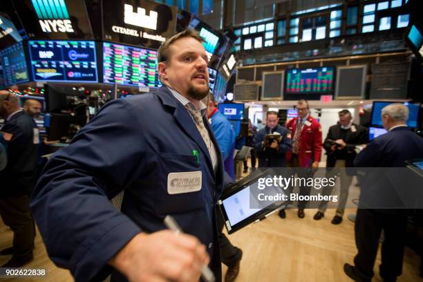 Trader works on the floor of the New York Stock Exchange in New York, U.S., on Monday, Jan. 8, 2018. U.S. Stocks were mixed, with the S&P 500 Index...