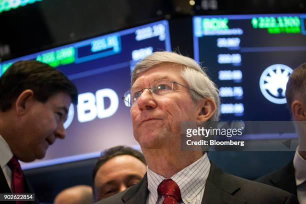 Vincent Forlenza, chairman and chief executive officer of Becton Dickinson & Co., center, stands on the floor of the New York Stock Exchange in New...