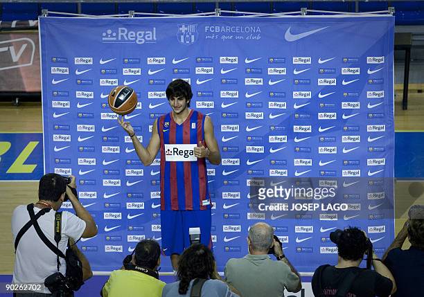 Spanish basketball player Ricky Rubio poses for a photographers with his new shirt on September 1, 2009 at the Nou Camp stadium in Barcelona during...