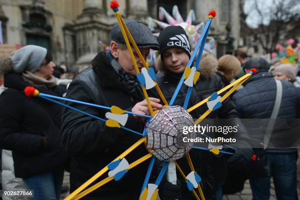 Father explain to his sonhow to hold a Christmas Stars when awaiting for the Christmas Stars Parade that take place in Lviv on the second day of...