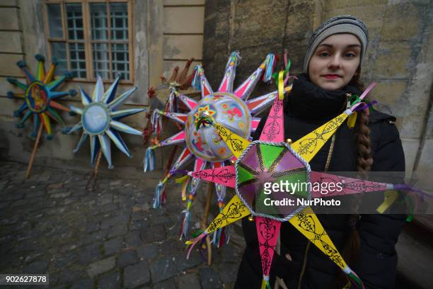 Young woman holds a Christmas Star when awaits for the Christmas Stars Parade that take place in Lviv on the second day of Christmas and run from...