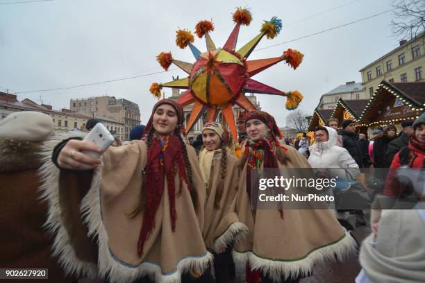 Group of young girls takes a selfie with their Christmas Star in front of Lviv's Opera at the end of the Christmas Stars Parade that took place in...