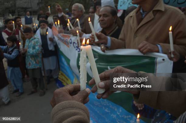 Pakistani activists of Bhagat Singh Memorial Foundation light candles during a protest in favor of Pak-India friendship outside Lahore Press Club in...