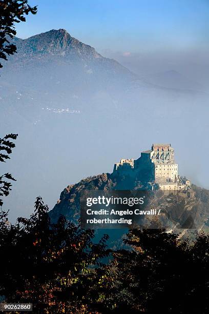 mount pirchiriano and sacra di san michele (saint michael's abbey), val di susa, piedmont, italy, europe - sacra di san michele foto e immagini stock