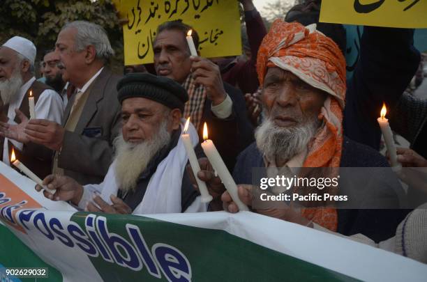 Pakistani activists of Bhagat Singh Memorial Foundation light candles during a protest in favor of Pak-India friendship outside Lahore Press Club in...