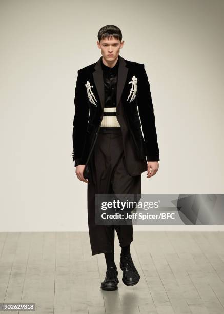 Model walks the runway at the D.GNAK show during London Fashion Week Men's January 2018 at BFC Show Space on January 8, 2018 in London, England.