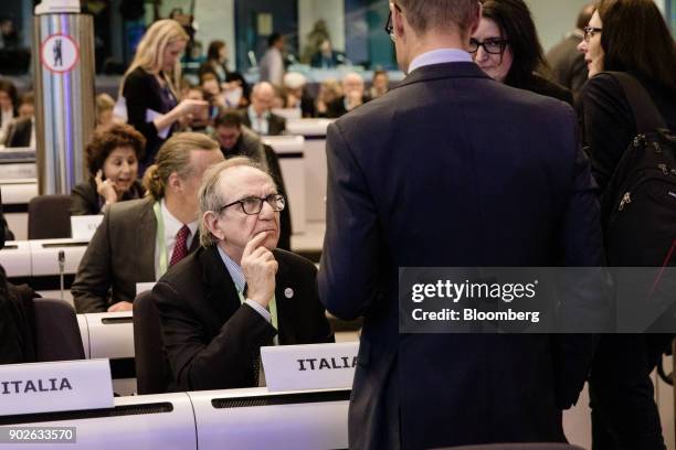 Pier Carlo Padoan, Italy's finance minister, left, speaks with attendees during the European Commission's financial framework conference in Brussels,...