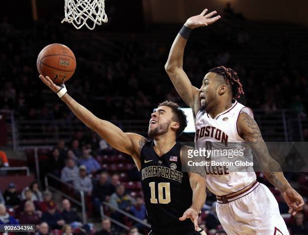 Wake Forest Demon Deacons guard Mitchell Wilbekin drives the lane as Boston College Eagles guard Ky Bowman goes up for the attempted block during the...