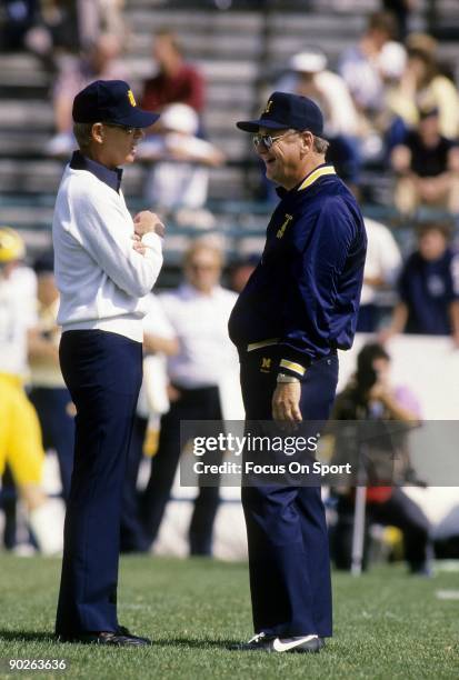 Head Coach Lou Holtz of the Notre Dame Fighting Irish talks with head coach Bo Schembechler of the University of Michigan before their NCAA football...