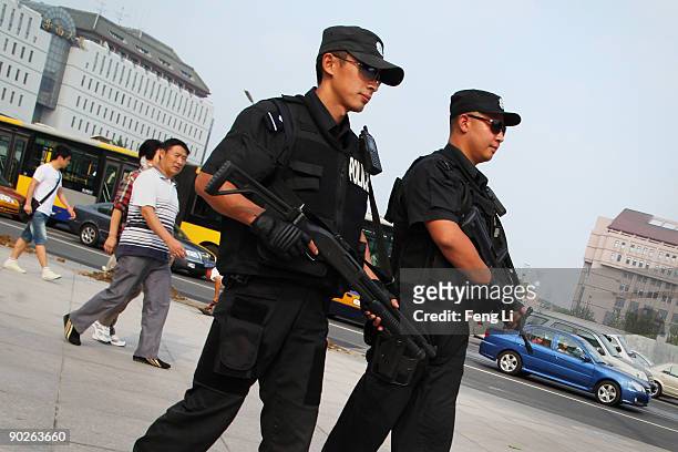 Armed policemen patrol on September 1, 2009 in Beijing, China. Chinese official media reported Tuesday that Beijing has begun raising its security...