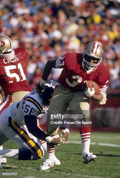 S: Running Back Roger Craig of the San Francisco 49ers carries the ball avoiding the tackle of Chris Doleman of the Minnesota Vikings during an NFL...