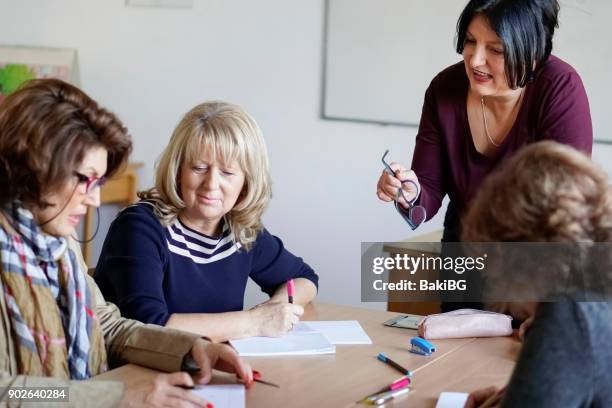 adult language learning - teaching english stock pictures, royalty-free photos & images