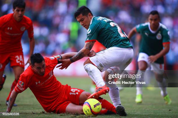 Rubens Sambueza of Toluca struggles for the ball with Michael Perez of Chivas during the first round match between Toluca and Chivas as part of the...
