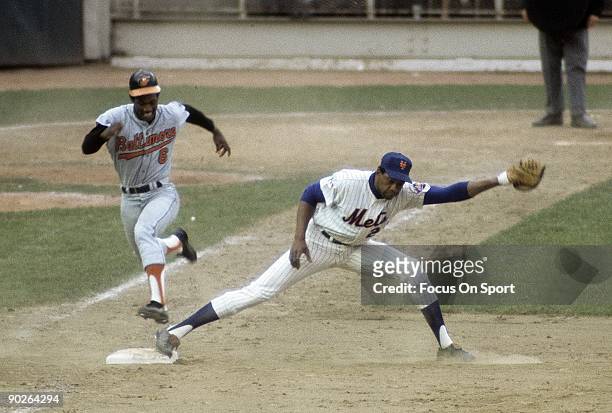 First baseman Donn Clendenon of the New York Mets stretches for the ball to get the put out at first as Paul Blair of the Baltimore Orioles tries to...