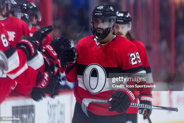 Ottawa Senators Defenceman Johnny Oduya skates by the bench to celebrate a goal during first period National Hockey League action between the Tampa...