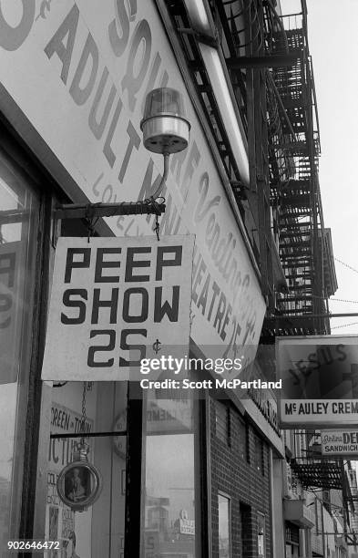 Exterior shot of an adult store featuring peep shows on 42nd street in Times Square, New York.