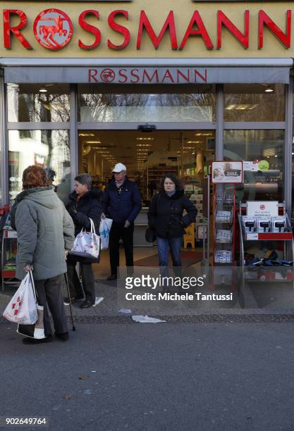 Pedestrians pass by a Rossmann Drogerie shop on January 8, 2018 in Berlin, Germany. According to government statisticians, nominal revenue grew...