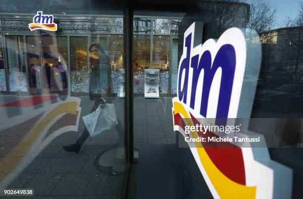 Pedestrians pass by a DM Drogerie Store on January 8, 2018 in Berlin, Germany. According to government statisticians, nominal revenue grew compared...