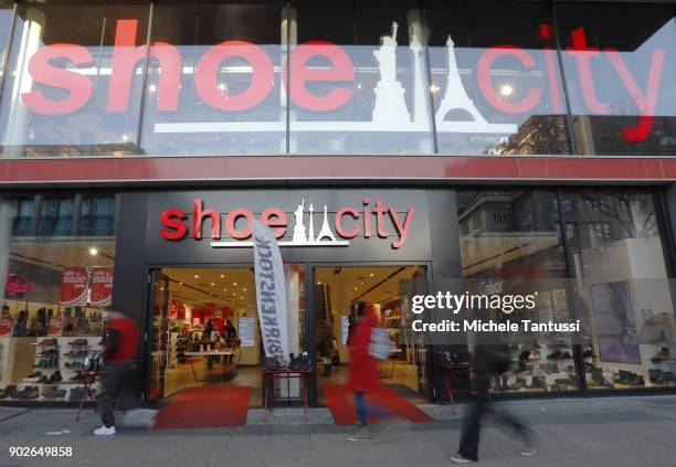 Pedestrians Pass by a Shoe City shop on January 8, 2018 in Berlin, Germany. According to government statisticians, nominal revenue grew compared to...