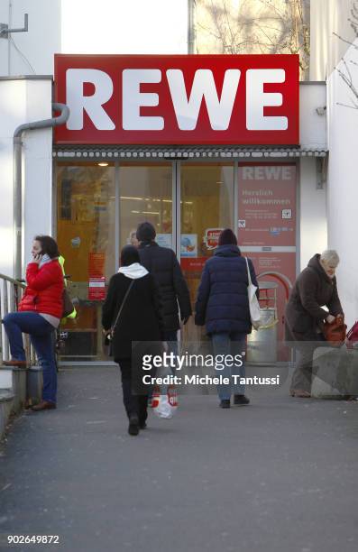 Pedestrians enter a REWE Supermarket on January 8, 2018 in Berlin, Germany. According to government statisticians, nominal revenue grew compared to...