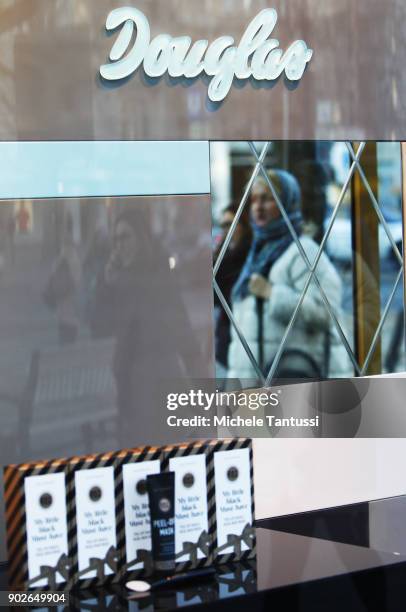 Pedestrians enter a Douglas parfum shop on January 8, 2018 in Berlin, Germany. According to government statisticians, nominal revenue grew compared...