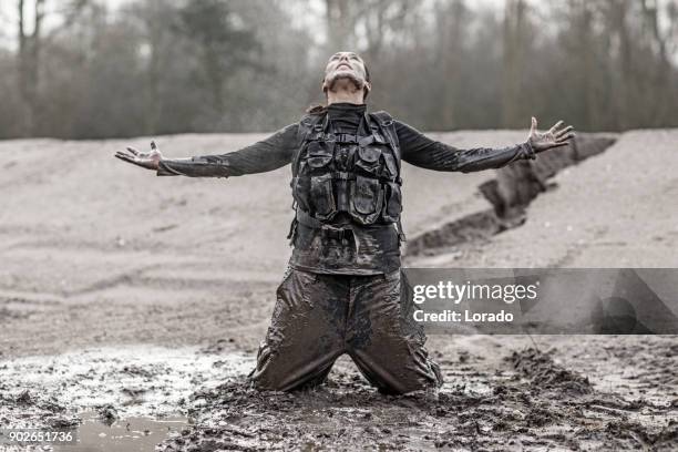 beautiful brunette female military member during training in muddy sand outdoors - platoon stock pictures, royalty-free photos & images