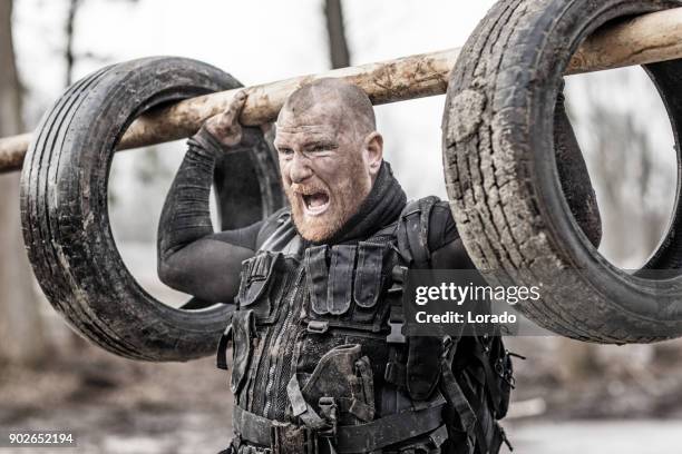 macho shaven headed redhead male military swat security anti terror member during training in muddy outdoor setting - military training stock pictures, royalty-free photos & images