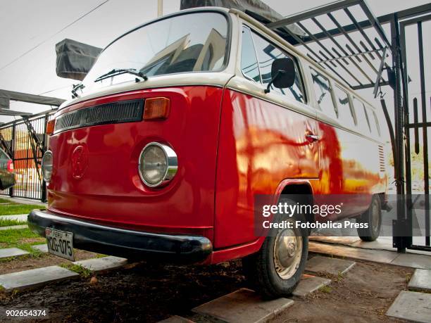 Angle view of a red and white Volkswagen T2 14 windows Brazilian Kombi.