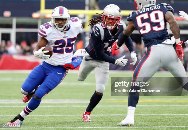 LeSean McCoy of the Buffalo Bills runs the ball past Stephon Gilmore of the New England Patriots during a game at Gillette Stadium on December 24,...