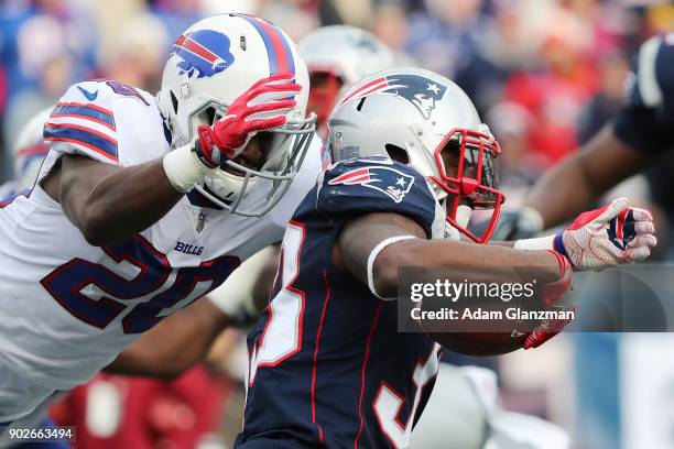 Dion Lewis of the New England Patriots is tackled by Shareece Wright of the Buffalo Bills during a game at Gillette Stadium on December 24, 2017 in...