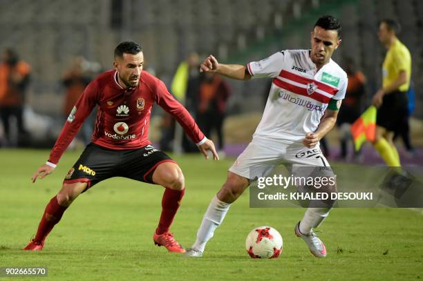 Egypts al-Ahly player Ali Maaloul fights for the ball against Zamalek's Hazem Immam during the the Egyptian Premier League football match between...
