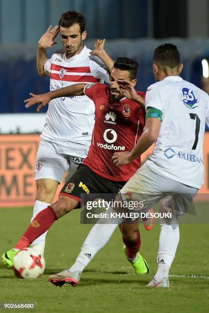 Egypts al-Ahly player Islam Moharb fights for the ball against Zamalek's Mahmoud Abdelaty and Hazem Immam during the the Egyptian Premier League...