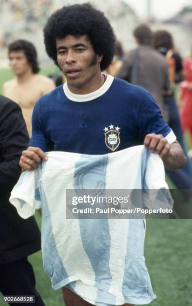 Jairzinho, who scored Brazil's winning goal, leaves the field with an Argentina shirt as a souvenir following the FIFA World Cup match between...