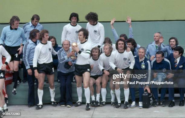 West Germany's captain Franz Beckenbauer and coach Helmut Schoen holding the trophy as the West German team celebrate after the FIFA World Cup Final...