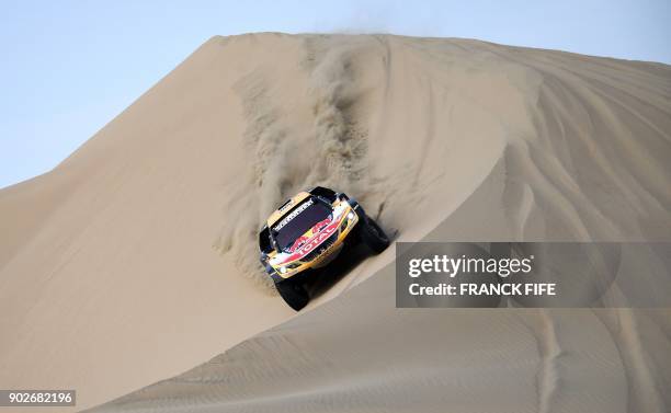 Peugeot's driver Stephane Peterhansel and his co-driver Jean Paul Cottret of France compete during the Stage 3 of the Dakar 2018 between Pisco and...