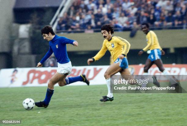 Paolo Rossi of Italy is chased by Roberto Rivelino of Brazil during the 3rd & 4th place play-off between Italy and Brazil at the Estadio Monumental...