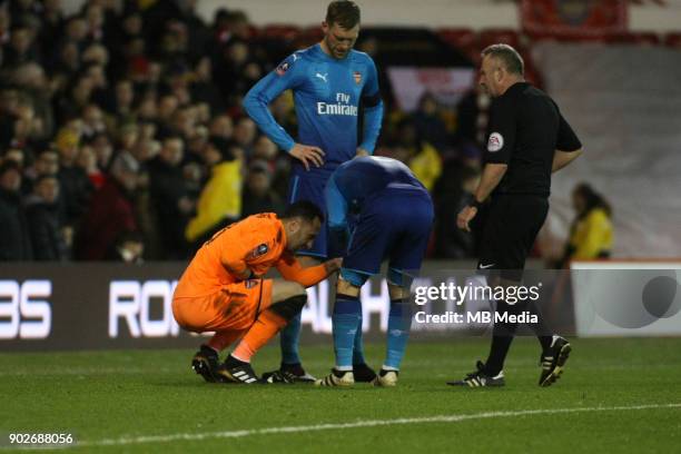 Arsenal Goalkeeper David Ospina has to rely on team mate Matthieu Debuchy to pop his dislocated finger back in during The Emirates FA Cup Third Round...