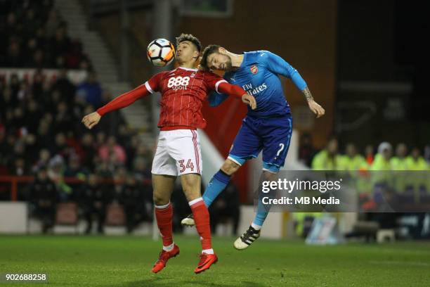 Tyler Walker beats Arsenal's Matthieu Debuchy to the ball during The Emirates FA Cup Third Round match between Nottingham Forest and Arsenal at City...