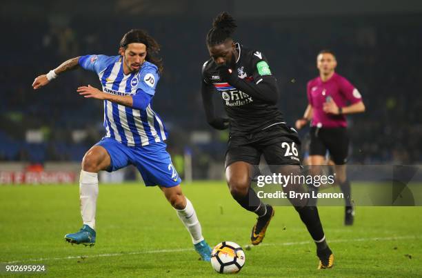 Bakary Sako of Crystal Palace is chased by Matias Ezequiel Schelotto of Brighton and Hove Albion during The Emirates FA Cup Third Round match between...